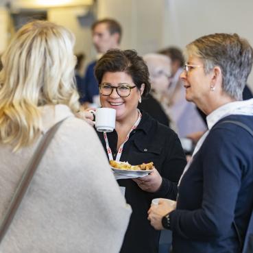 Förtroendevalda personer i OK ekonomisk föreningen samtalar över en kopp kaffe.